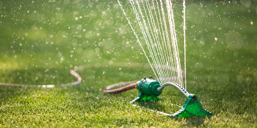 best way to water grass without sprinkler system