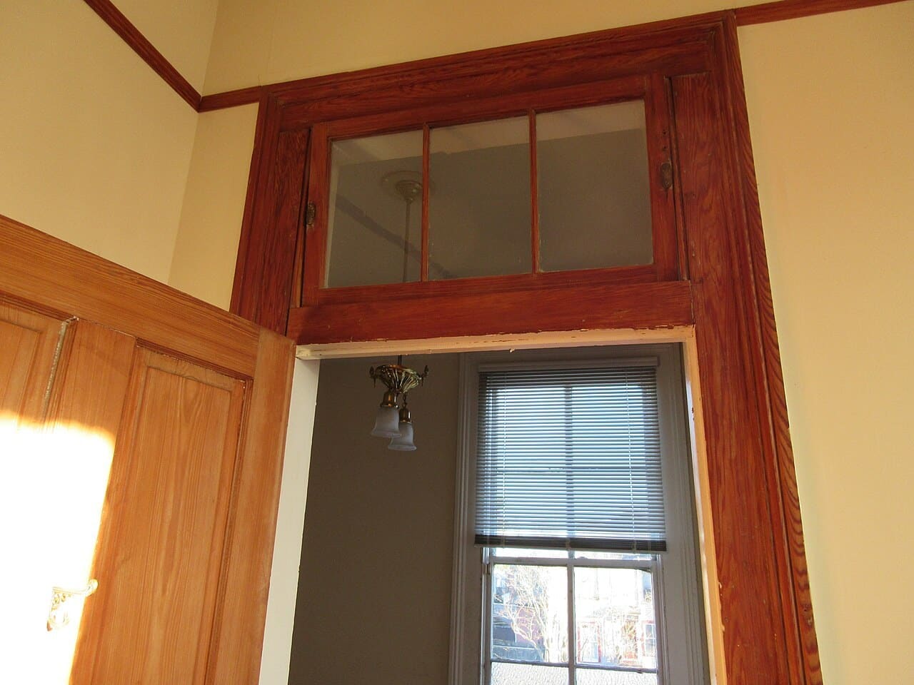 Wood-framed transom above an interior doorway in a New Orleans house